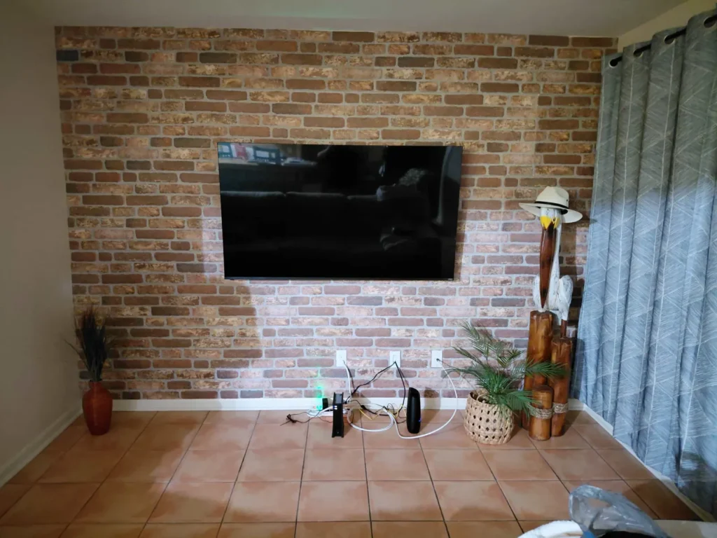 TV wall mount installation on brick accent wall with cable concealment in Ocala Florida