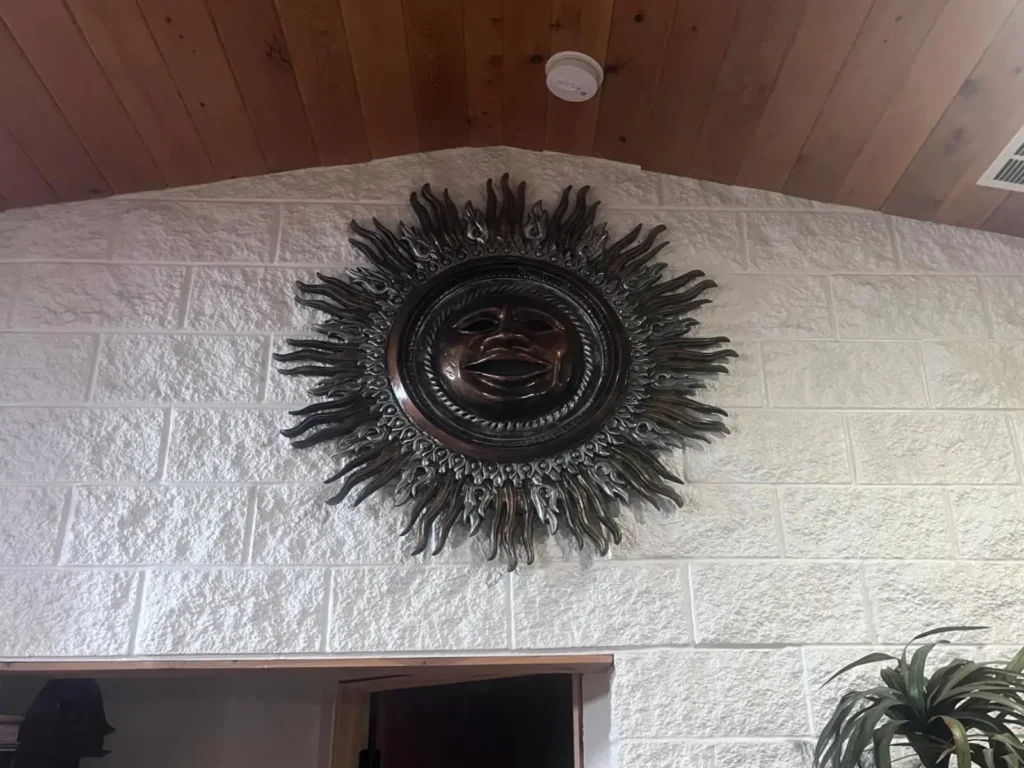 Large decorative wall art installation on stone wall in Belleview Florida