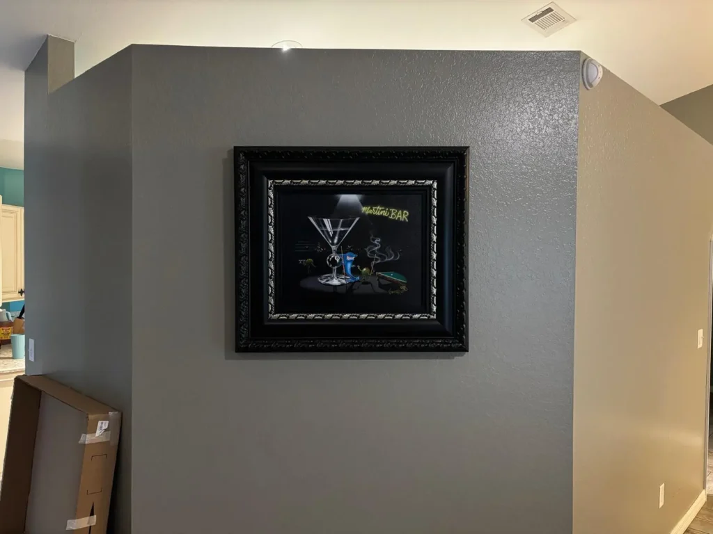 Framed artwork wall installation in Ocala Florida