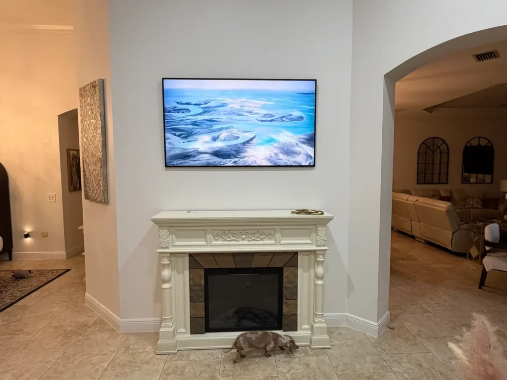 Samsung Frame TV mounted above fireplace mantel in The Villages Florida