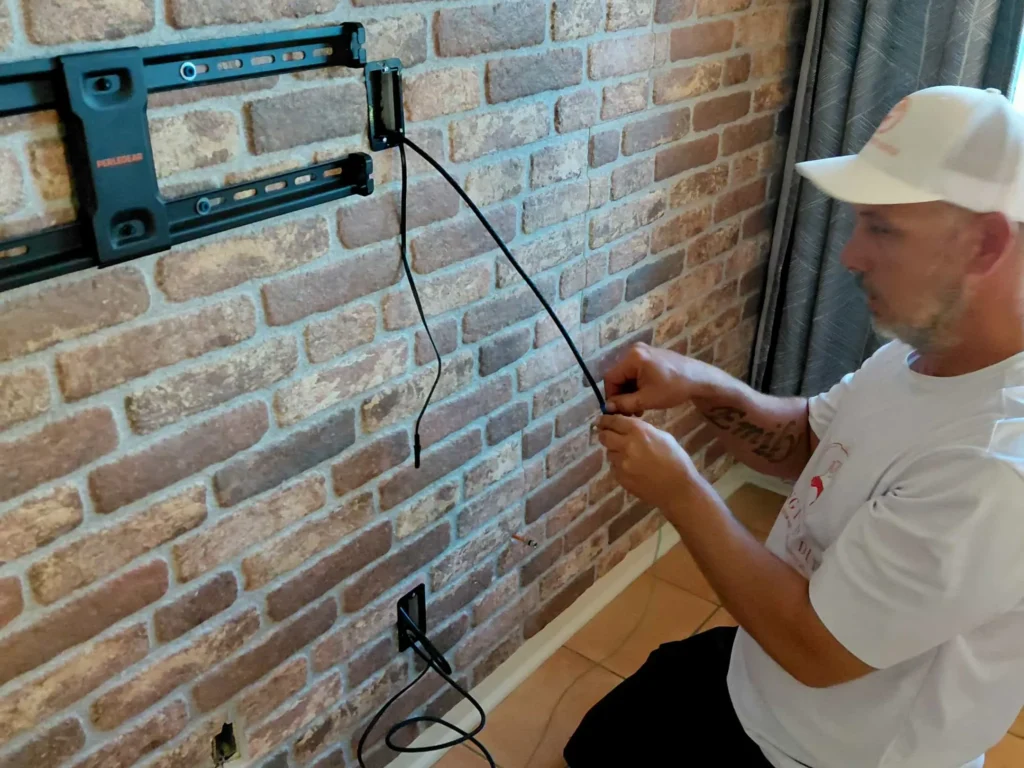 TV wall mount installation with cable concealment on brick wall in Dunnellon Florida