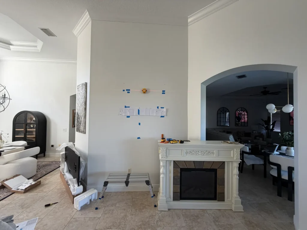 Laser level layout setup for TV mount installation on wall in Silver Springs Florida