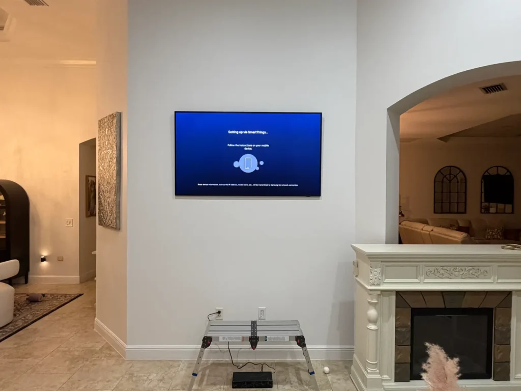 TV mounted above electric fireplace on white wall in Ocala Florida