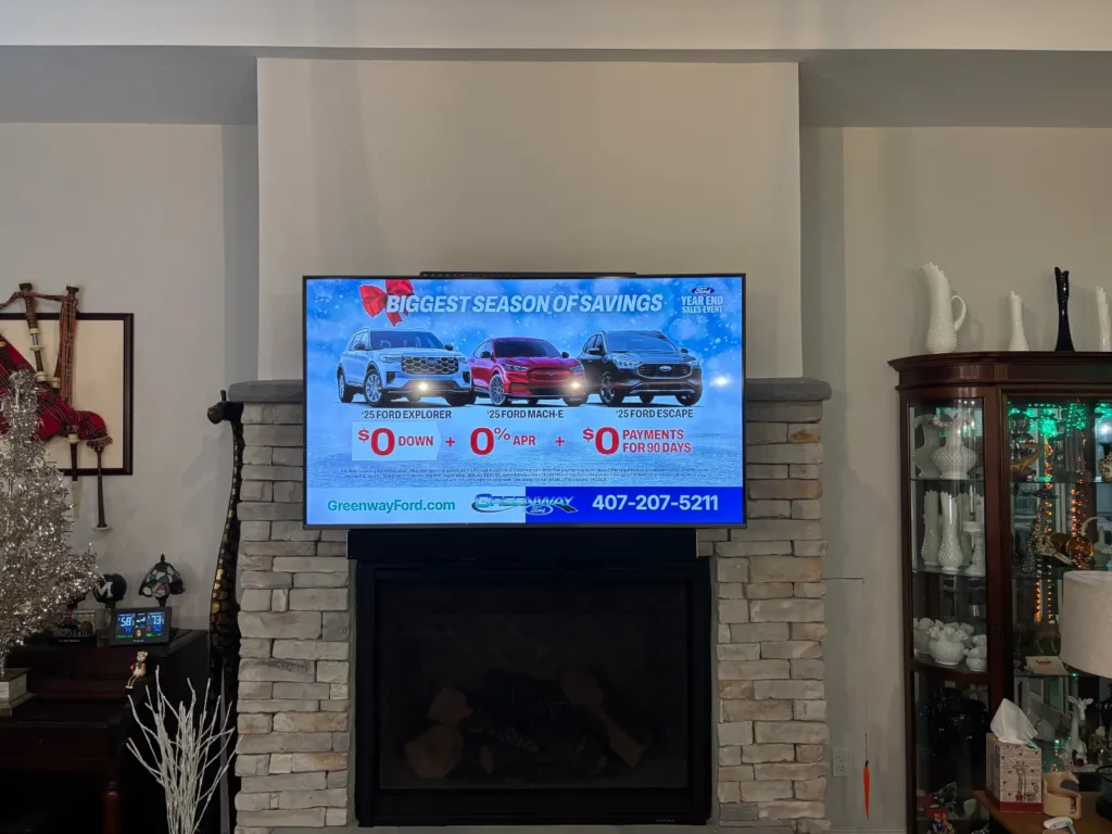 Pull down TV mount installed above stone fireplace in Belleview Florida