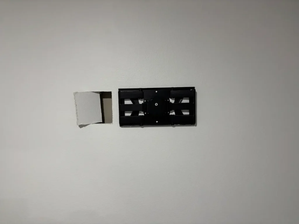 Wall cutout for in wall cable concealment during TV installation in Ocala Florida