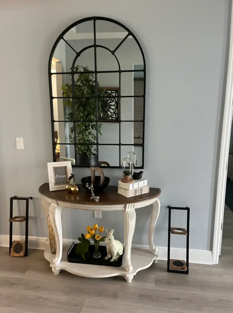 Entryway arched mirror installation in Ocala Florida professionally mounted and centered above table