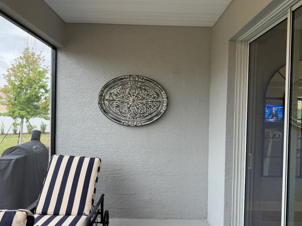 Decorative outdoor wall art professionally installed on patio wall in Ocala Florida