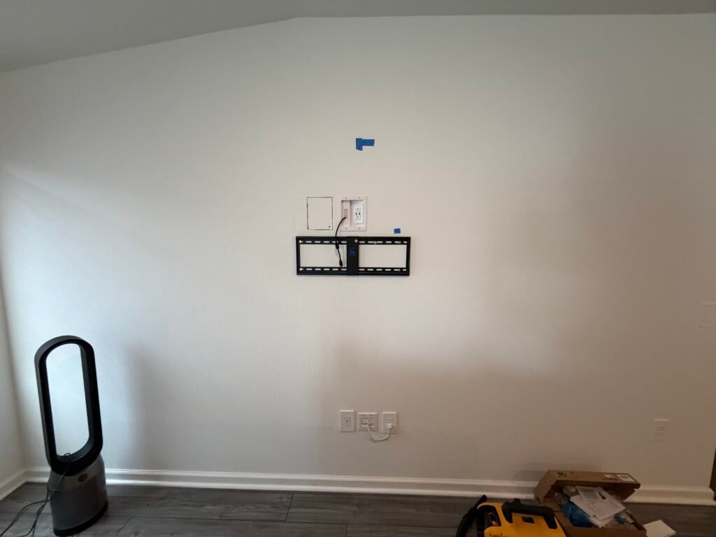 Professional in-wall cable concealment behind a wall-mounted TV in Belleview, Florida.