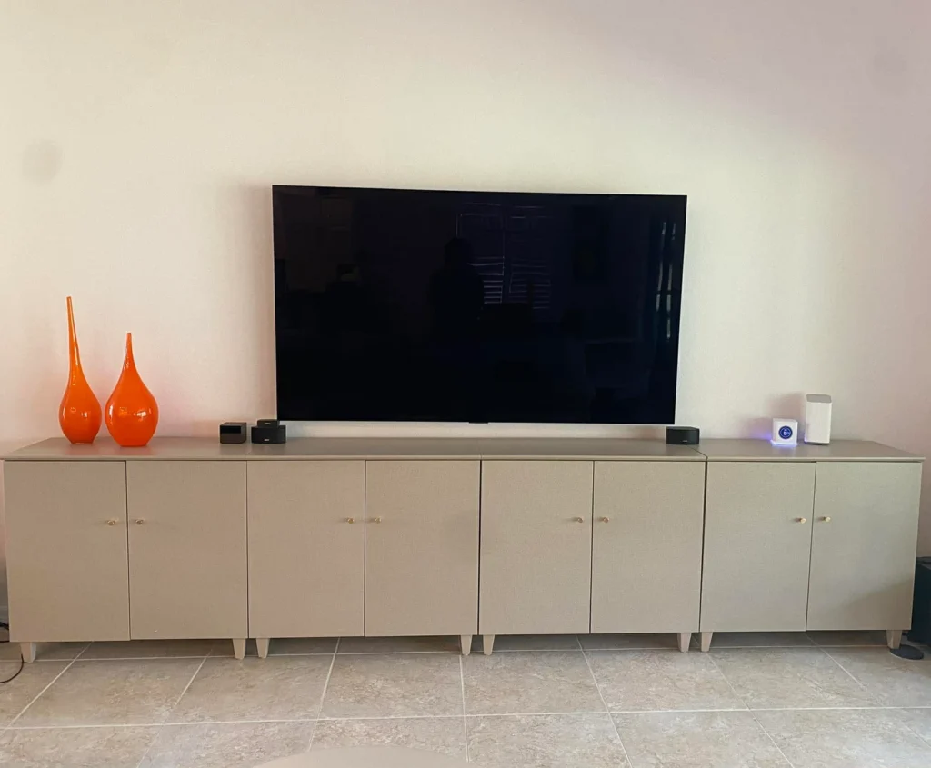 Large TV wall mounting above media console in Summerfield, Florida
