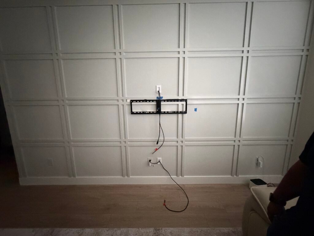 Clean in-wall TV wire concealment installation on a decorative feature wall in Summerfield, Florida.