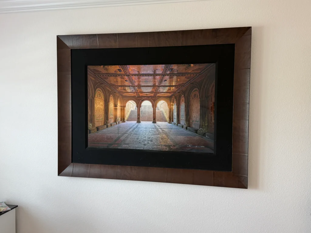 Heavy decorative wall art securely installed and perfectly centered in a bedroom in Ocala, Florida.