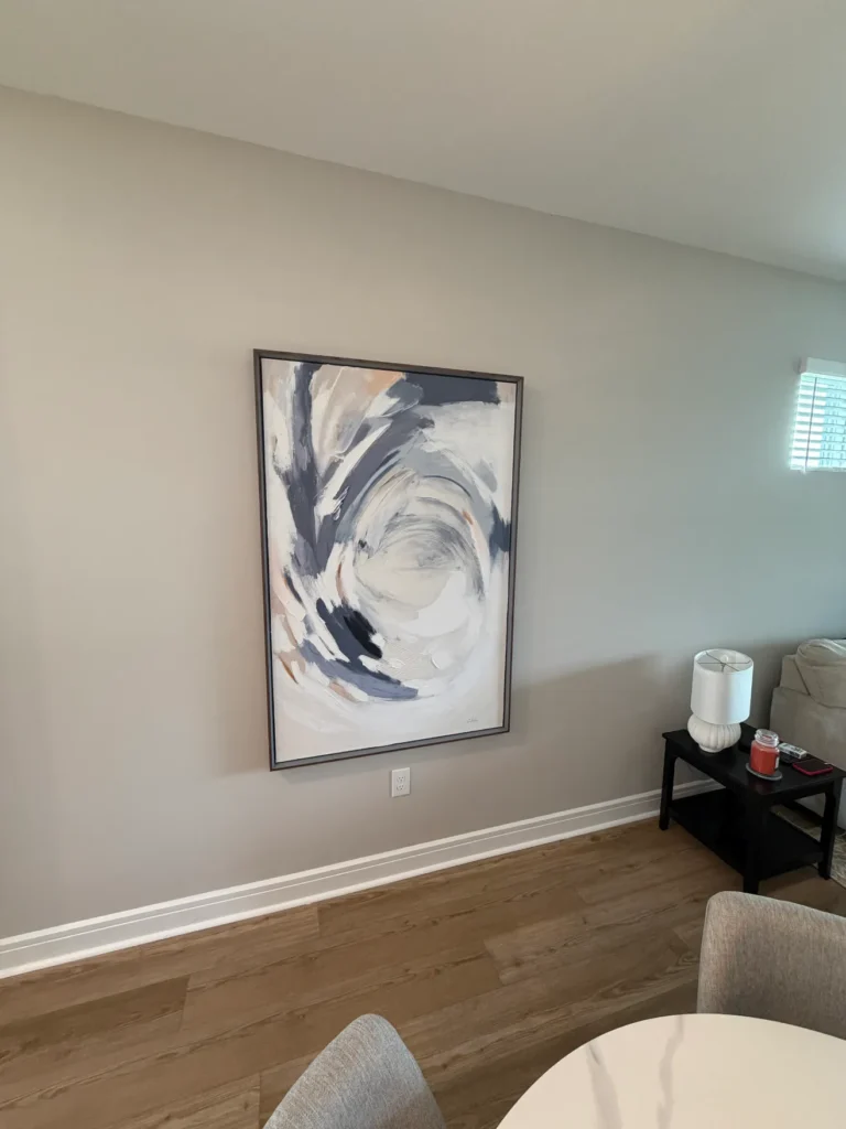 Large framed abstract artwork professionally mounted on a living room wall in Ocala Florida