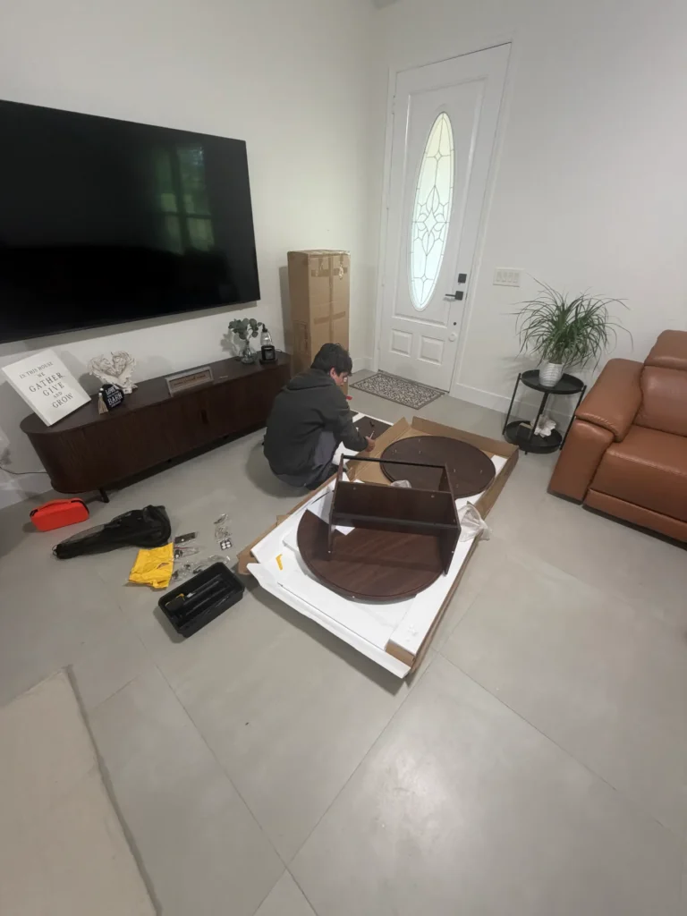 Round wood coffee table being assembled with hardware and tools in Ocala Florida